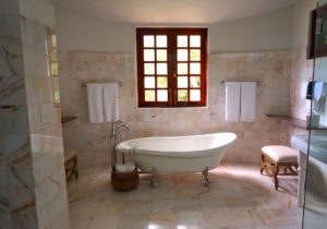 Large luxurious bathroom with tile floor.